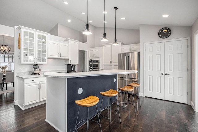 5591 Pioneer Ave, Saint Joseph, MI 49085 - kitchen with a kitchen breakfast bar, glass insert cabinets, stainless steel appliances, white cabinetry, and a kitchen island