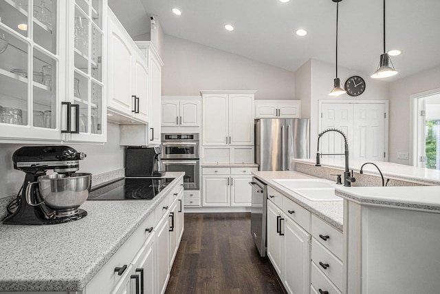 5591 Pioneer Ave, Saint Joseph, MI 49085 - kitchen with white cabinets, vaulted ceiling, appliances with stainless steel finishes, and a sink