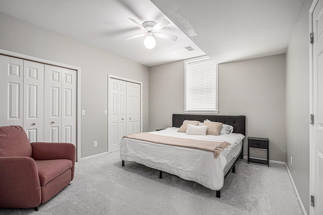 5591 Pioneer Ave, Saint Joseph, MI 49085 - bedroom with multiple closets, baseboards, light carpet, and visible vents