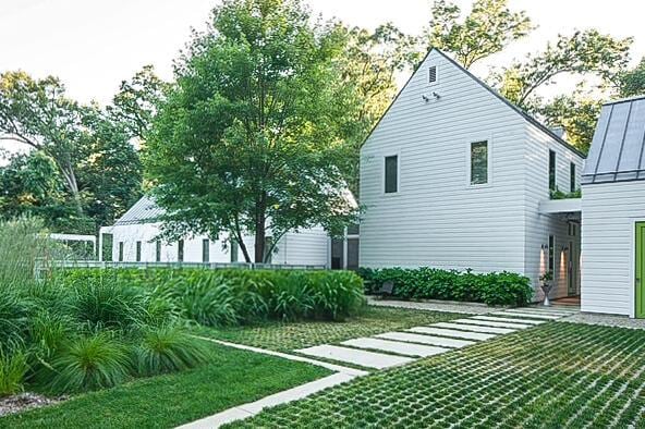 rear view of property featuring a yard, a standing seam roof, and metal roof
