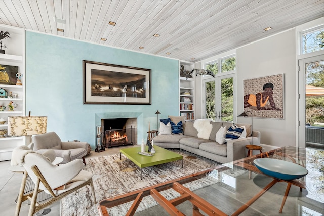 living room featuring french doors, built in features, wood ceiling, and a premium fireplace
