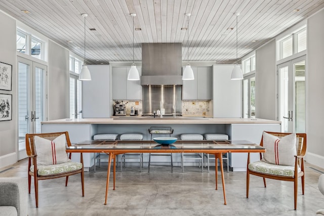 dining area with wood ceiling, baseboards, french doors, and concrete floors
