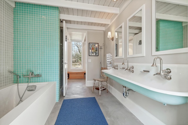 full bathroom featuring beamed ceiling, baseboards, a bathing tub, wooden ceiling, and finished concrete floors
