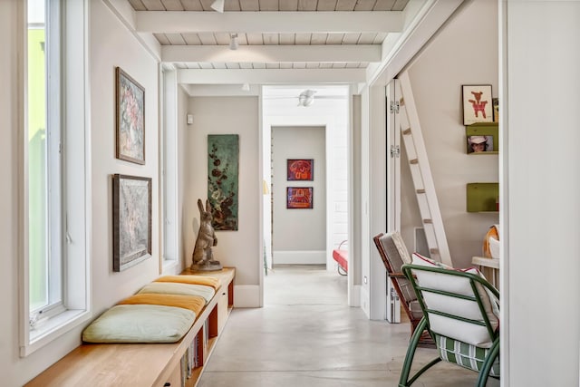 corridor featuring wooden ceiling, beamed ceiling, and finished concrete floors