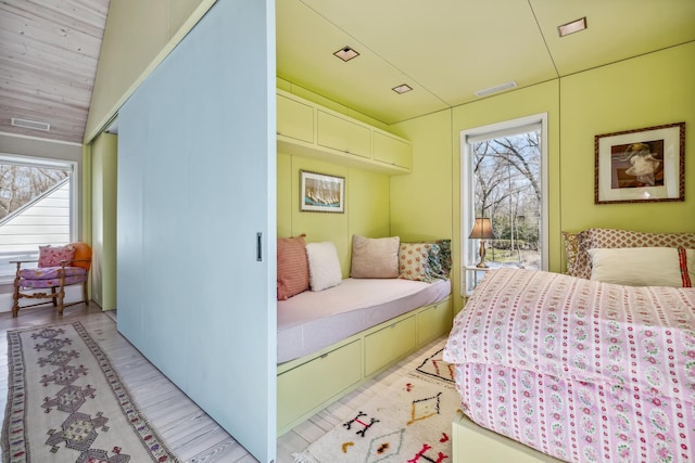 bedroom with visible vents, light wood-style flooring, and multiple windows