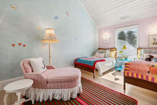 bedroom featuring wood-type flooring, wood ceiling, lofted ceiling, and visible vents