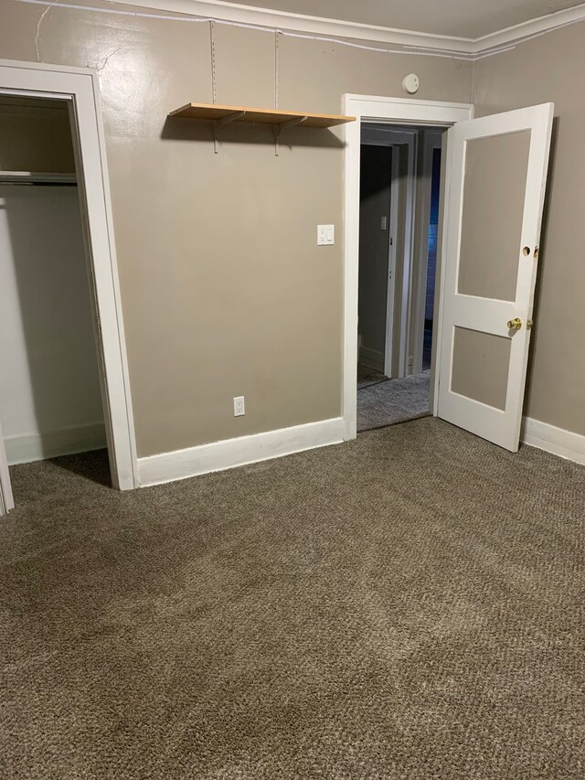 802 Dupont St, Flint, MI 48504 - unfurnished bedroom featuring baseboards, carpet, a closet, and ornamental molding