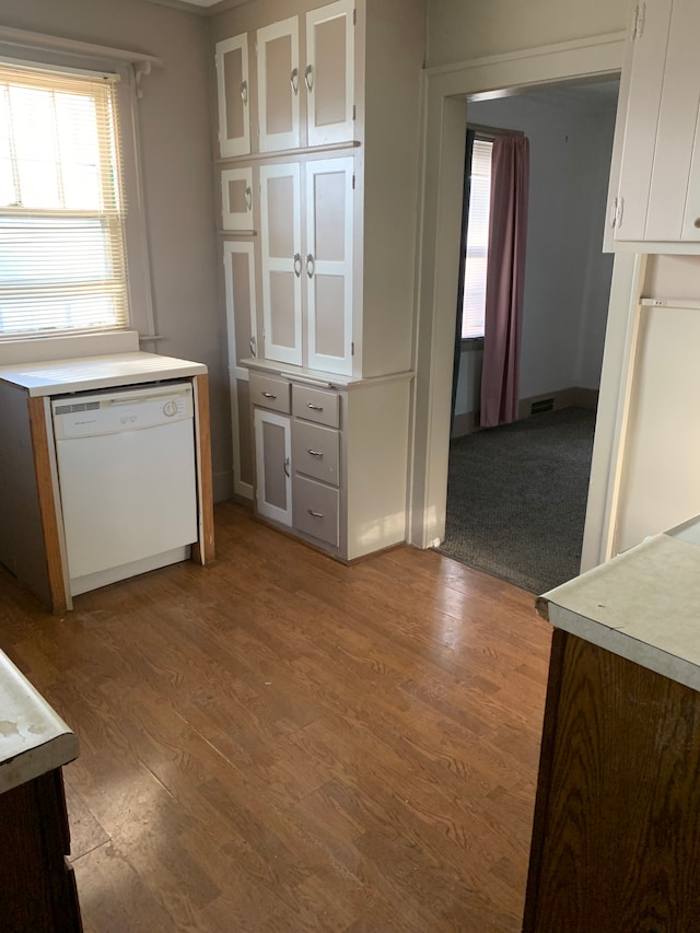 802 Dupont St, Flint, MI 48504 - kitchen featuring plenty of natural light, white cabinetry, white dishwasher, wood finished floors, and light countertops
