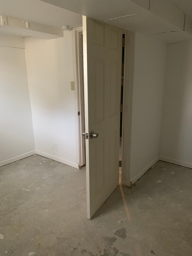 802 Dupont St, Flint, MI 48504 - empty room featuring concrete flooring and baseboards