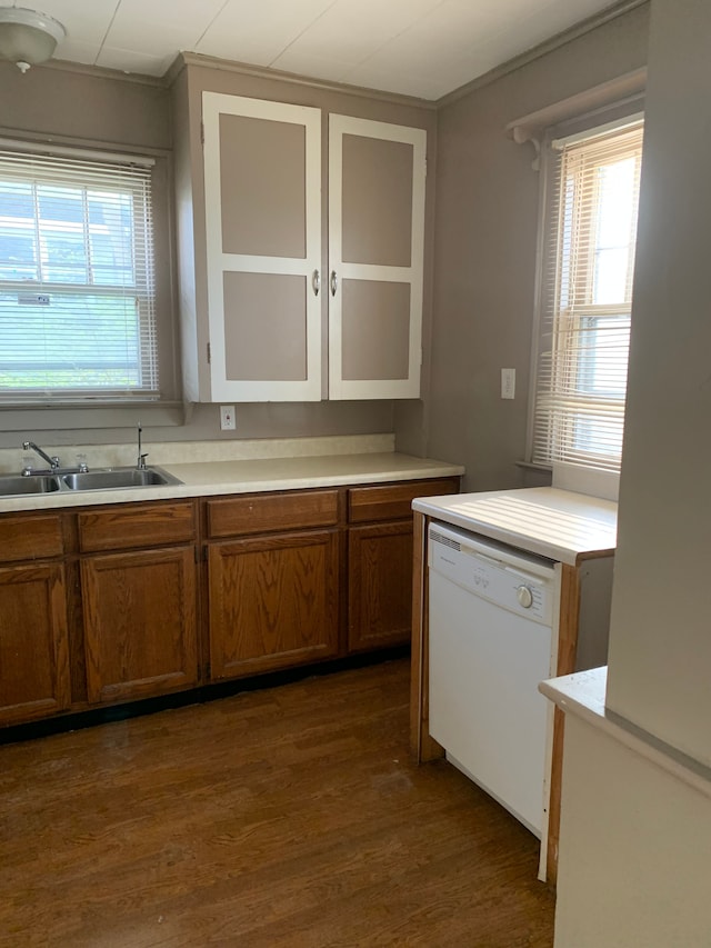 802 Dupont St, Flint, MI 48504 - kitchen with brown cabinets, dark wood finished floors, light countertops, dishwasher, and a sink