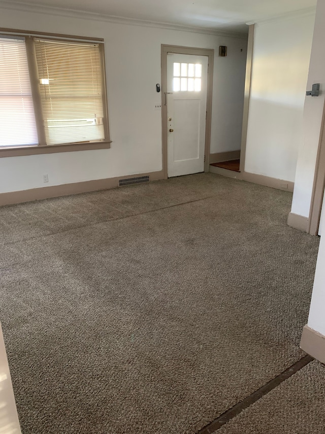 802 Dupont St, Flint, MI 48504 - entrance foyer with visible vents, carpet floors, and crown molding