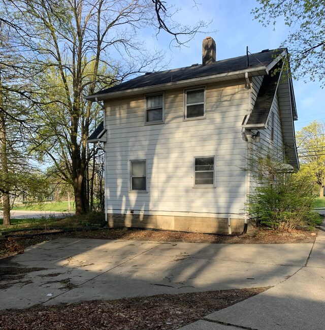 802 Dupont St, Flint, MI 48504 - view of home's exterior with a chimney and a patio