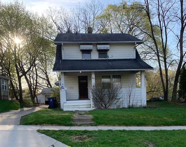 802 Dupont St, Flint, MI 48504 - view of front of home featuring a front yard, a chimney, and covered porch