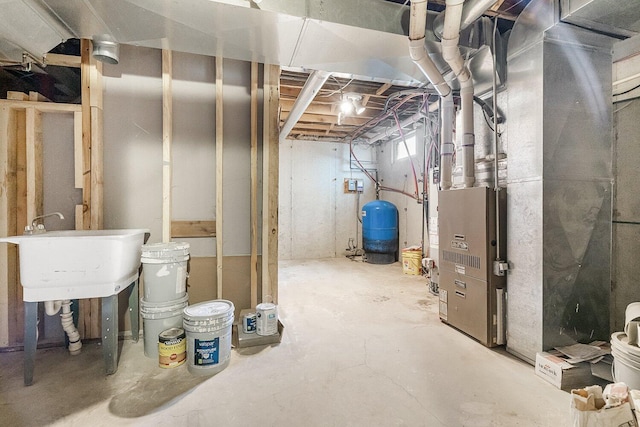 unfinished basement with heating unit and a sink