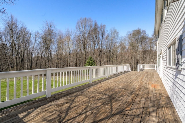 wooden terrace featuring a yard