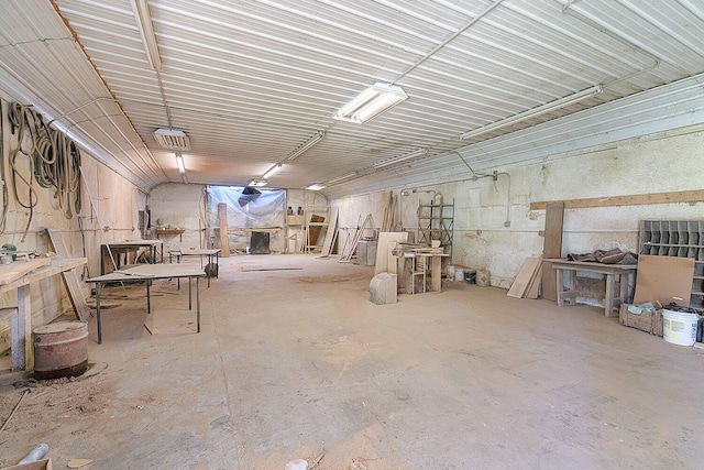 misc room featuring a workshop area and unfinished concrete floors