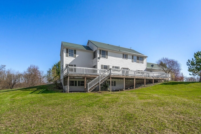 rear view of house featuring a yard, stairs, metal roof, and a deck