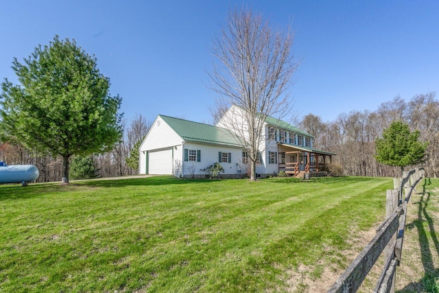 view of yard featuring fence and a garage