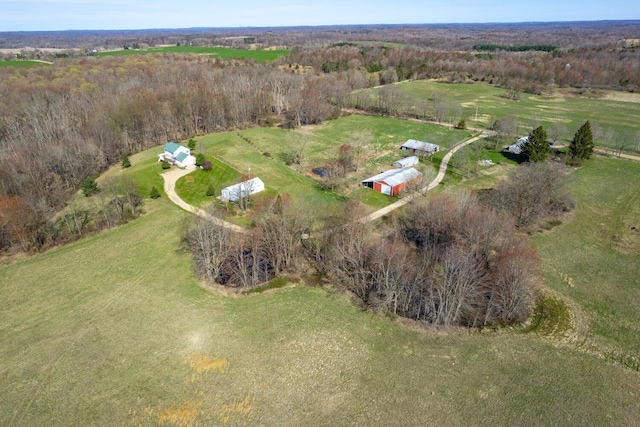 birds eye view of property with a view of trees and a rural view
