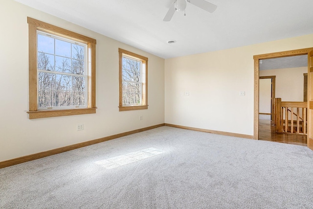 spare room with baseboards, a ceiling fan, and carpet flooring