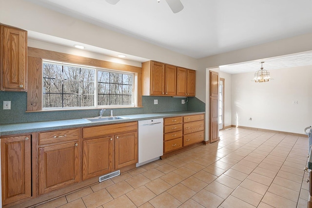 kitchen with a sink, visible vents, decorative backsplash, dishwasher, and light tile patterned floors