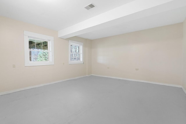 spare room featuring visible vents and baseboards