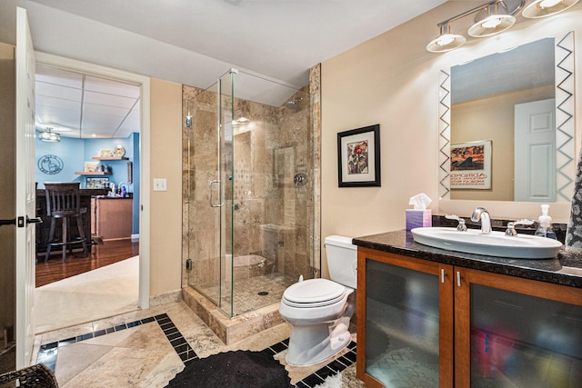 9037 Yorkshire Dr, Saline, MI 48176 - bathroom featuring a shower stall, toilet, vanity, and tile patterned floors
