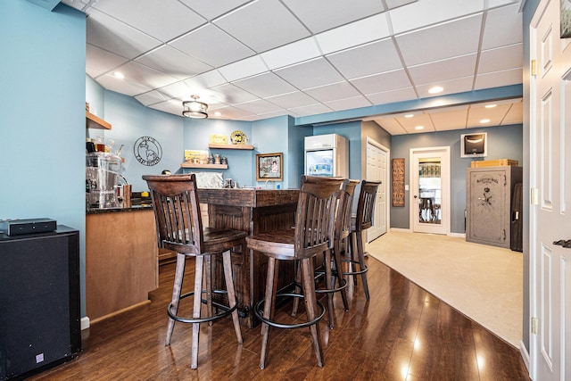 9037 Yorkshire Dr, Saline, MI 48176 - bar with indoor bar, a paneled ceiling, baseboards, and wood-type flooring