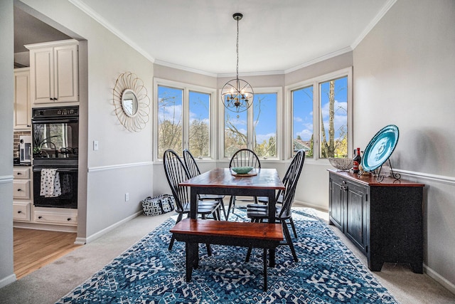 9037 Yorkshire Dr, Saline, MI 48176 - dining area featuring ornamental molding, baseboards, a chandelier, and light colored carpet