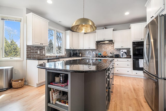 9037 Yorkshire Dr, Saline, MI 48176 - kitchen with white cabinetry, light wood-style floors, and appliances with stainless steel finishes