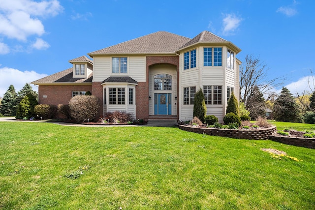 9037 Yorkshire Dr, Saline, MI 48176 - traditional-style home with brick siding, a front yard, and roof with shingles