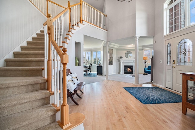 9037 Yorkshire Dr, Saline, MI 48176 - entrance foyer with wood finished floors, a towering ceiling, ornate columns, and stairway