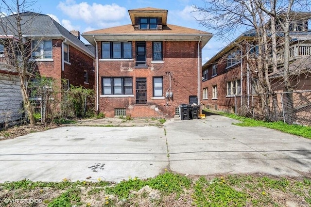 rear view of house featuring brick siding