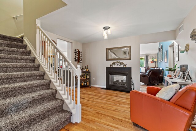 6240 Northridge Hills Dr, Brighton, MI 48116 - living room with light wood-style floors, stairway, a multi sided fireplace, and baseboards