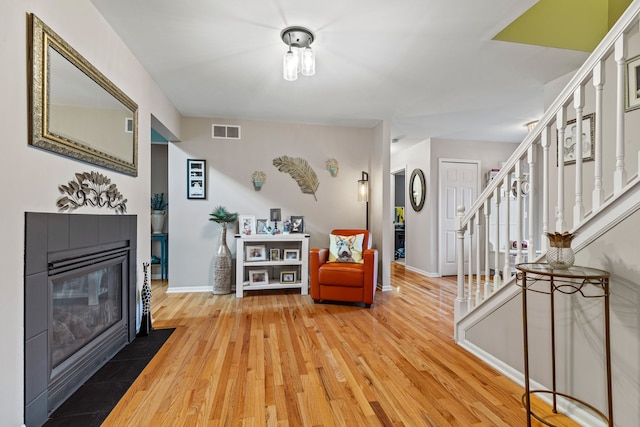 6240 Northridge Hills Dr, Brighton, MI 48116 - entrance foyer featuring light wood-type flooring, stairway, baseboards, and a fireplace
