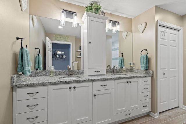 6240 Northridge Hills Dr, Brighton, MI 48116 - full bath featuring double vanity, wood finish floors, and baseboards