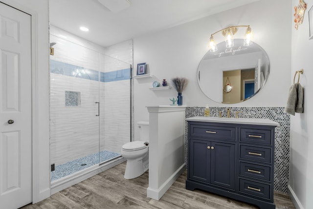 6240 Northridge Hills Dr, Brighton, MI 48116 - bathroom with toilet, wood finished floors, a shower stall, vanity, and baseboards