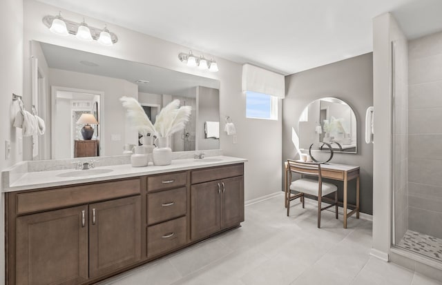 bathroom featuring a tile shower, double vanity, baseboards, and a sink