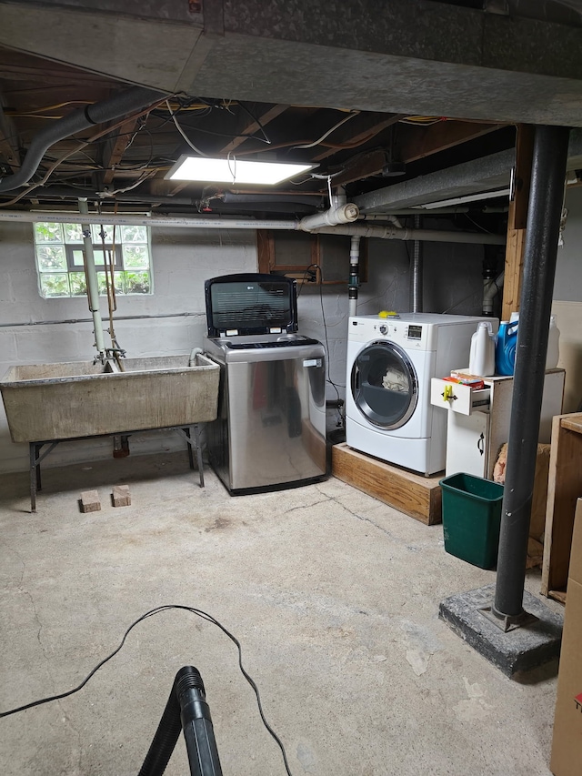 basement with washer and clothes dryer and a sink