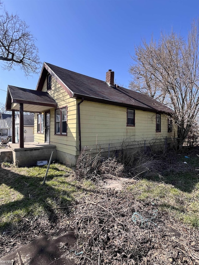 1048 Tremont Ave, Flint, MI 48505 - view of side of property featuring a chimney