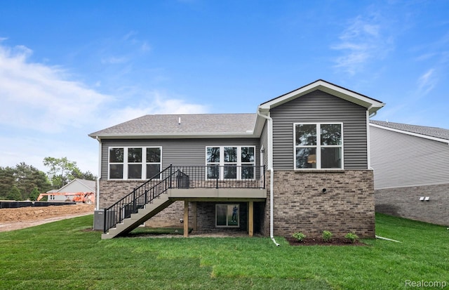 3058 Sheffield Cir, Clarkston, MI 48346 - rear view of property featuring stairway, brick siding, a deck, and a lawn