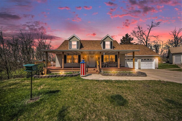 10500 Woodland Dr, Jerome, MI 49249 - view of front of house with an outbuilding, driveway, covered porch, a garage, and a front yard