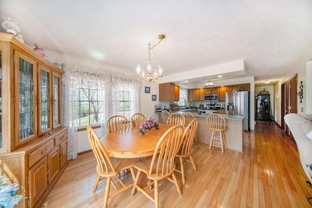 10500 Woodland Dr, Jerome, MI 49249 - dining area featuring recessed lighting, a chandelier, and light wood-style floors