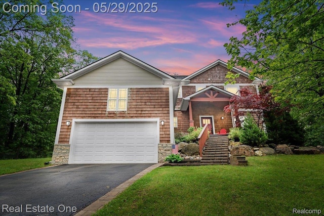 9327 Van Antwerp Rd, Brighton, MI 48116 - view of front of property featuring asphalt driveway, a lawn, an attached garage, and stone siding