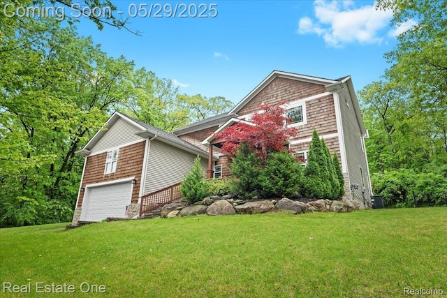 9327 Van Antwerp Rd, Brighton, MI 48116 - view of front of house with a front lawn, a garage, and central AC unit