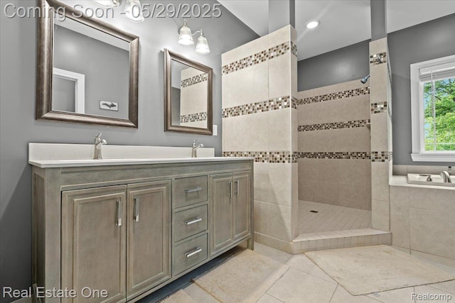 9327 Van Antwerp Rd, Brighton, MI 48116 - full bath featuring tile patterned flooring, walk in shower, double vanity, and a relaxing tiled tub