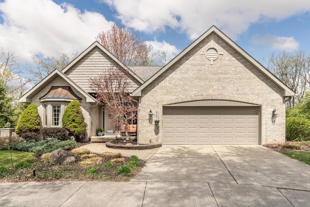 70 Chestnut Ct, Chelsea, MI 48118 - view of front of house with concrete driveway, an attached garage, and brick siding