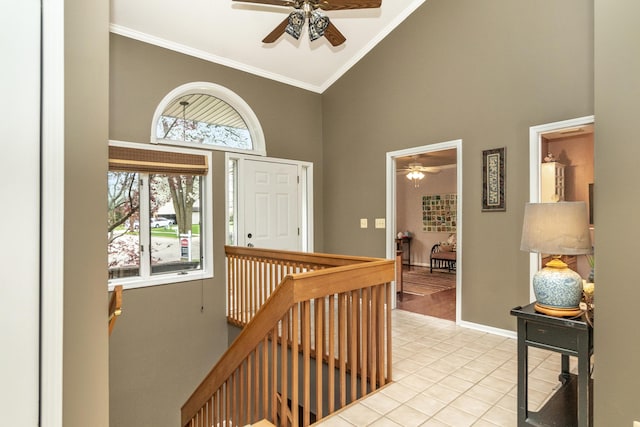 70 Chestnut Ct, Chelsea, MI 48118 - foyer with crown molding, a ceiling fan, light tile patterned floors, and high vaulted ceiling