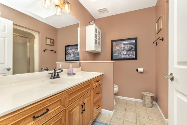 70 Chestnut Ct, Chelsea, MI 48118 - bathroom featuring visible vents, a stall shower, toilet, vanity, and tile patterned flooring