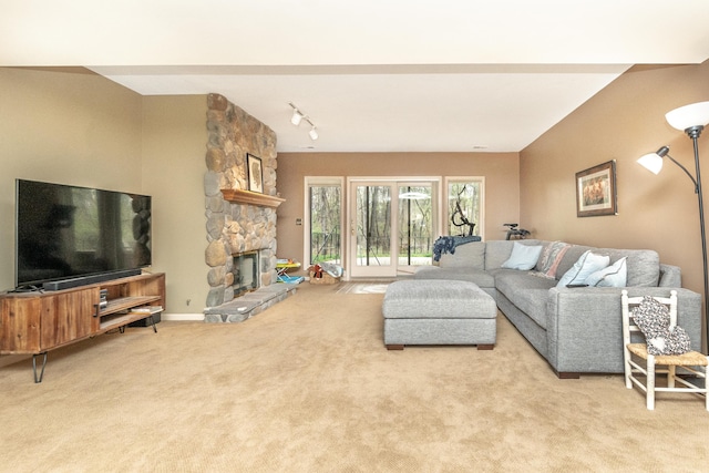 70 Chestnut Ct, Chelsea, MI 48118 - carpeted living area featuring track lighting and a stone fireplace